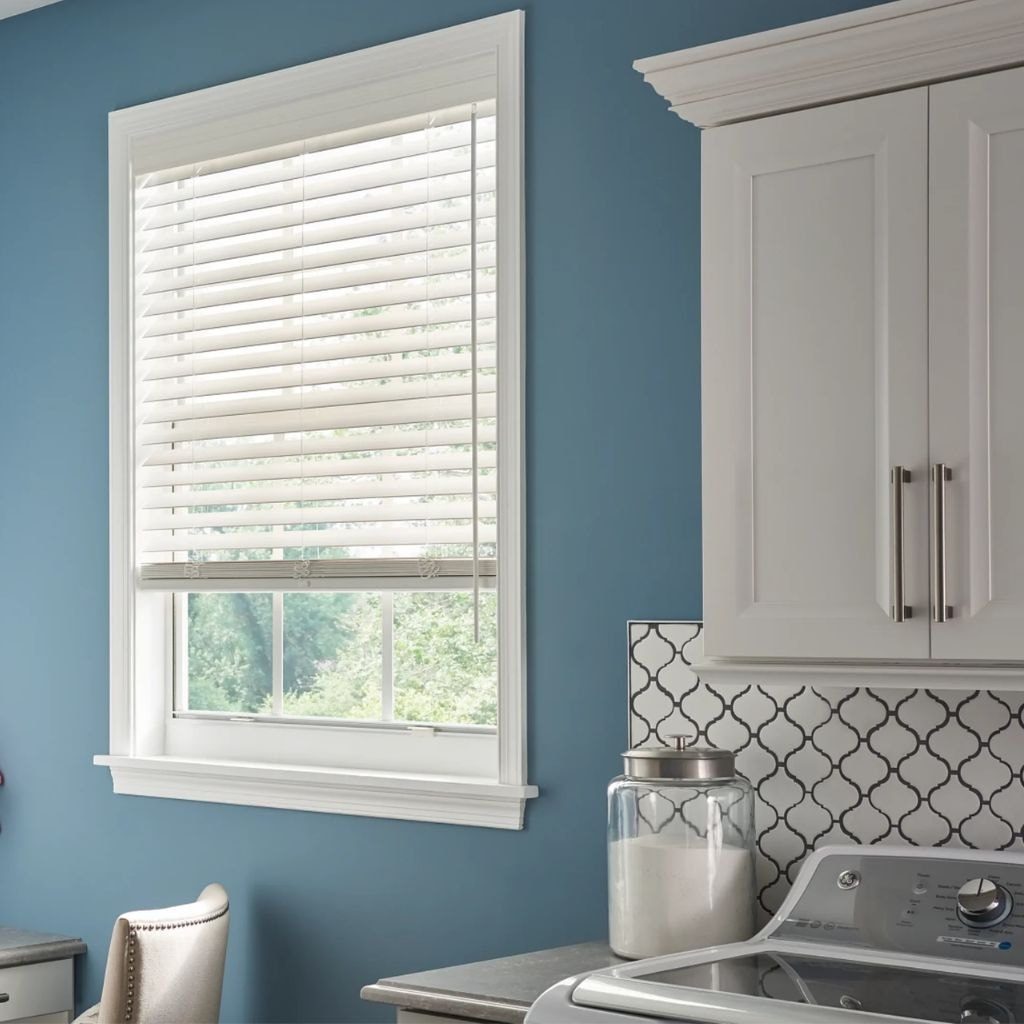 Faux wood Venetian blinds above the sink in a bright Vancouver kitchen