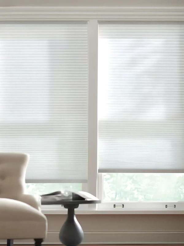Close-up of white cellular honeycomb shade fabric showing the sealed cell structure